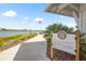 Lakehouse Cove at Waterside sign near a lake with an American flag at 8229 Grande Shores Dr, Sarasota, FL 34240