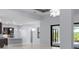 Open-concept living space connecting the kitchen and living area, featuring tile floors at 8229 Grande Shores Dr, Sarasota, FL 34240