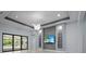 Living room area with sliding glass doors, custom shelving, and modern lighting at 8229 Grande Shores Dr, Sarasota, FL 34240