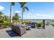 Comfortable outdoor seating area with beautiful water views and lush landscaping at 8229 Grande Shores Dr, Sarasota, FL 34240
