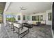 A spacious covered patio with fan, TV and plenty of seating, great for entertaining at 8229 Grande Shores Dr, Sarasota, FL 34240