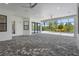 Neutral stone-look tiled patio area offering ample space for seating and lounging by the screened in pool at 8229 Grande Shores Dr, Sarasota, FL 34240