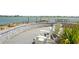 Scenic patio with a paver wall and tranquil lake views, perfect for relaxation at 8229 Grande Shores Dr, Sarasota, FL 34240