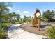 Community playground with swings, slide, and other play structures at 8229 Grande Shores Dr, Sarasota, FL 34240