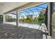 Screened in pool and patio area that features lush landscaping, clear skies, and ample space for outdoor enjoyment at 8229 Grande Shores Dr, Sarasota, FL 34240