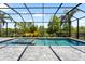 Beautiful screened pool with hot tub, offering a relaxing retreat with clear water and lush landscaping at 8229 Grande Shores Dr, Sarasota, FL 34240