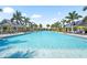 Stunning community pool surrounded by palm trees and cabanas, offering a luxurious resort-style experience at 8229 Grande Shores Dr, Sarasota, FL 34240