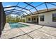 Inviting screened pool featuring a spa, and ample lounge space for relaxation with views of the manicured backyard at 8229 Grande Shores Dr, Sarasota, FL 34240
