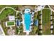 Aerial view of a luxurious swimming pool with palm trees, lounge chairs, and a recreational area surrounded by lush landscaping at 8229 Grande Shores Dr, Sarasota, FL 34240