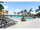 Resort-style pool with plenty of lounge seating, palm trees, and a covered gazebo for relaxing by the pool at 8229 Grande Shores Dr, Sarasota, FL 34240