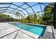 A screened in backyard pool with a spa is the perfect place to unwind at 8229 Grande Shores Dr, Sarasota, FL 34240