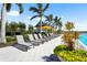 Resort-style pool with plenty of lounge seating, palm trees, and a covered gazebo for relaxing by the pool at 8229 Grande Shores Dr, Sarasota, FL 34240