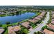 Scenic aerial view of a home featuring a serene lake backdrop and meticulously landscaped yard at 8297 Barton Farms Blvd, Sarasota, FL 34240