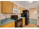 Efficient kitchen features matching black appliances and functional layout at 835 70Th E Dr, Sarasota, FL 34243