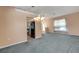 Open living space features a chandelier, large window and access to kitchen and outdoor patio at 835 70Th E Dr, Sarasota, FL 34243