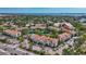 Condo complex with pool, parking, green landscaping, and mature trees with views of the bay at 850 S Tamiami Trl # 624, Sarasota, FL 34236