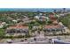 Aerial view of a condo complex with a pool, mature trees and landscaping, and views of the bay at 850 S Tamiami Trl # 624, Sarasota, FL 34236