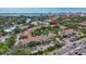 Aerial view showcasing the community's pool, mature trees, and proximity to the bay at 850 S Tamiami Trl # 624, Sarasota, FL 34236