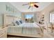 Cozy bedroom featuring balcony access, serene decor, and a ceiling fan for added comfort at 850 S Tamiami Trl # 624, Sarasota, FL 34236