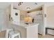 Functional kitchen with counter seating and white appliances at 850 S Tamiami Trl # 624, Sarasota, FL 34236