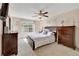 Cozy bedroom features a large window, ceiling fan, and dark wood furniture at 850 S Tamiami Trl # 624, Sarasota, FL 34236