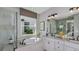 Luxurious bathroom featuring a soaking tub, separate shower, double vanity, and elegant fixtures at 8579 Big Dipper Dr, Sarasota, FL 34241