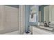 Cozy bathroom with granite counter tops, and decorative shower curtain and white tiling at 8579 Big Dipper Dr, Sarasota, FL 34241