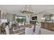 Open-concept dining area with modern lighting, stylish furniture, and seamless transition to the living room at 8579 Big Dipper Dr, Sarasota, FL 34241