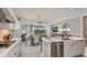 Bright and airy kitchen with a spacious island, stainless steel appliances, and open layout to dining and living areas at 8579 Big Dipper Dr, Sarasota, FL 34241