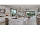 Open kitchen with stainless steel appliances and a large central island, looking to the living area at 8579 Big Dipper Dr, Sarasota, FL 34241