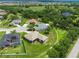 An aerial view of a charming single-story home with a sprawling lawn and screened-in porch at 9106 Yarberry St, Sarasota, FL 34240