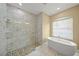 Bathroom boasts soaking tub, glass-enclosed shower, and tasteful tile work at 9106 Yarberry St, Sarasota, FL 34240
