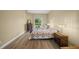 Cozy bedroom showcasing a bed with a handmade quilt and natural light from a window at 9106 Yarberry St, Sarasota, FL 34240