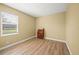 Neutral bedroom has wood floors, one window, and a small cabinet at 9106 Yarberry St, Sarasota, FL 34240