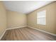 This bedroom has wood floors and one window at 9106 Yarberry St, Sarasota, FL 34240