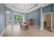 Bright dining room features a modern chandelier, tray ceiling, and sliding glass doors at 9106 Yarberry St, Sarasota, FL 34240
