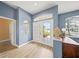 A bright foyer with wood floors, a transom window above the door, a decorative table, and interior doors at 9106 Yarberry St, Sarasota, FL 34240
