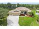 Attractive single-Gathering home with a spacious driveway, three-car garage, tidy landscaping, and a covered front entryway at 9106 Yarberry St, Sarasota, FL 34240