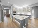 Open-concept kitchen with gray cabinets, white countertops, and stainless steel appliances at 9106 Yarberry St, Sarasota, FL 34240