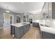 Gourmet kitchen with island, modern cabinets, and adjacent breakfast nook with patio access at 9106 Yarberry St, Sarasota, FL 34240
