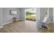 Bright living room offering sliding glass door with backyard views and a comfortable chair at 9106 Yarberry St, Sarasota, FL 34240