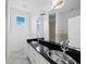 Elegant bathroom with double sinks, granite countertop, a large mirror, and tiled floors at 9315 9Th Nw Ave, Bradenton, FL 34209