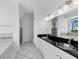 Luxurious bathroom featuring double sinks, a soaking tub, a walk-in shower, and tile flooring at 9315 9Th Nw Ave, Bradenton, FL 34209