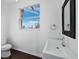 Bright bathroom featuring a modern sink, a toilet, and a window with a tropical view at 9315 9Th Nw Ave, Bradenton, FL 34209