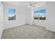 Light-filled bedroom with neutral carpet, two large windows, and ample natural light at 9315 9Th Nw Ave, Bradenton, FL 34209