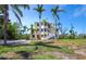 Stunning multi-level home with ample windows, white stairs, and surrounded by lush tropical landscaping at 9315 9Th Nw Ave, Bradenton, FL 34209