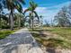 Paver driveway leading to a stunning multi-level home surrounded by lush tropical landscaping at 9315 9Th Nw Ave, Bradenton, FL 34209