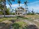 Stunning multi-level home with ample windows, white stairs, and surrounded by lush tropical landscaping at 9315 9Th Nw Ave, Bradenton, FL 34209