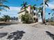 Beautiful home featuring a garage, a pool, and a brick driveway nestled amid swaying palm trees at 9315 9Th Nw Ave, Bradenton, FL 34209