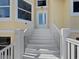 Front entrance with white stairs leading to a welcoming door framed by sidelights and windows at 9315 9Th Nw Ave, Bradenton, FL 34209